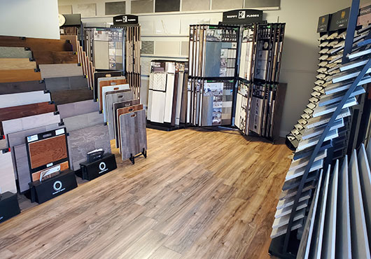 Customers can choose from extensive displays of flooring in Sunstate Home Design LLC’s showroom, including tile (left) and quartz. 